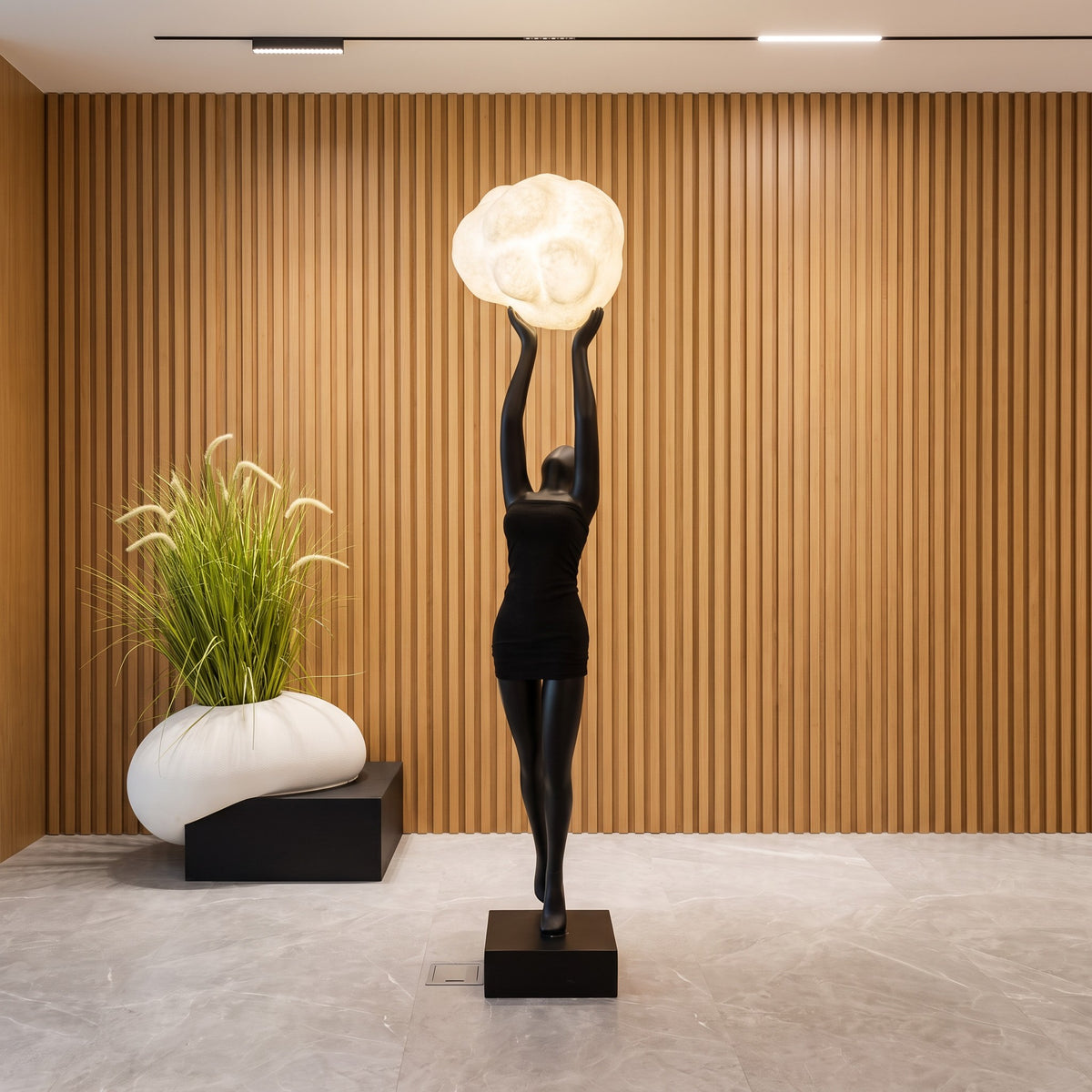 Creative resin figurine of a woman holding a cloud-like lamp, perfect for modern home decor
